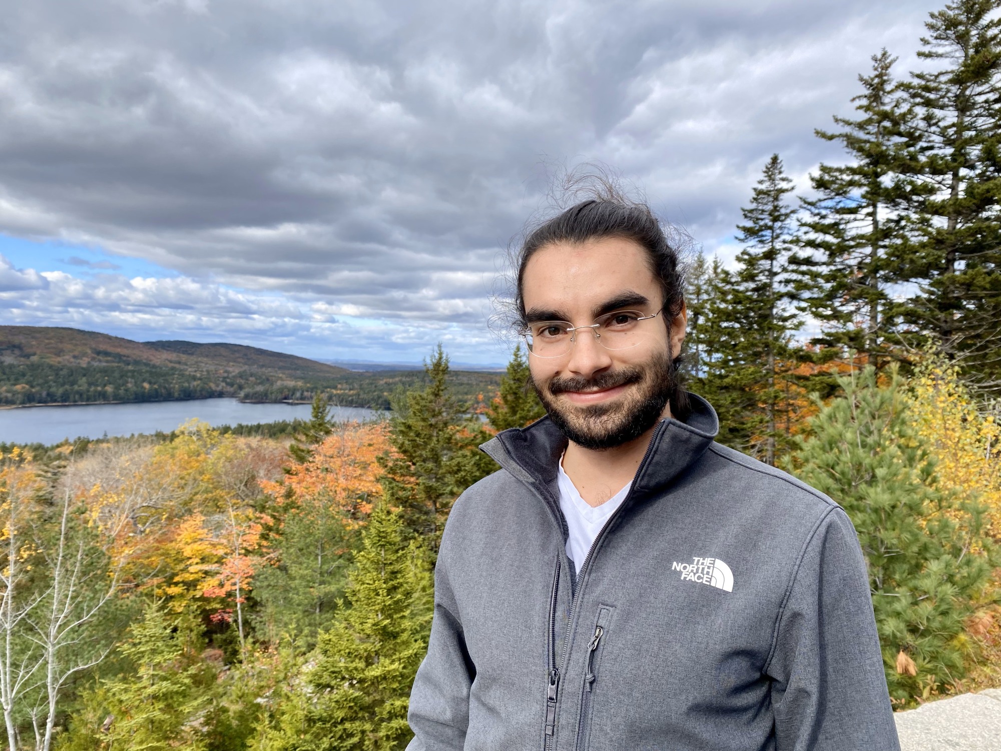 image of John Antolik  in a grey jacket in front of fall trees