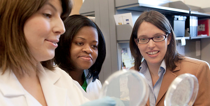 Professor and student examining petri dishes