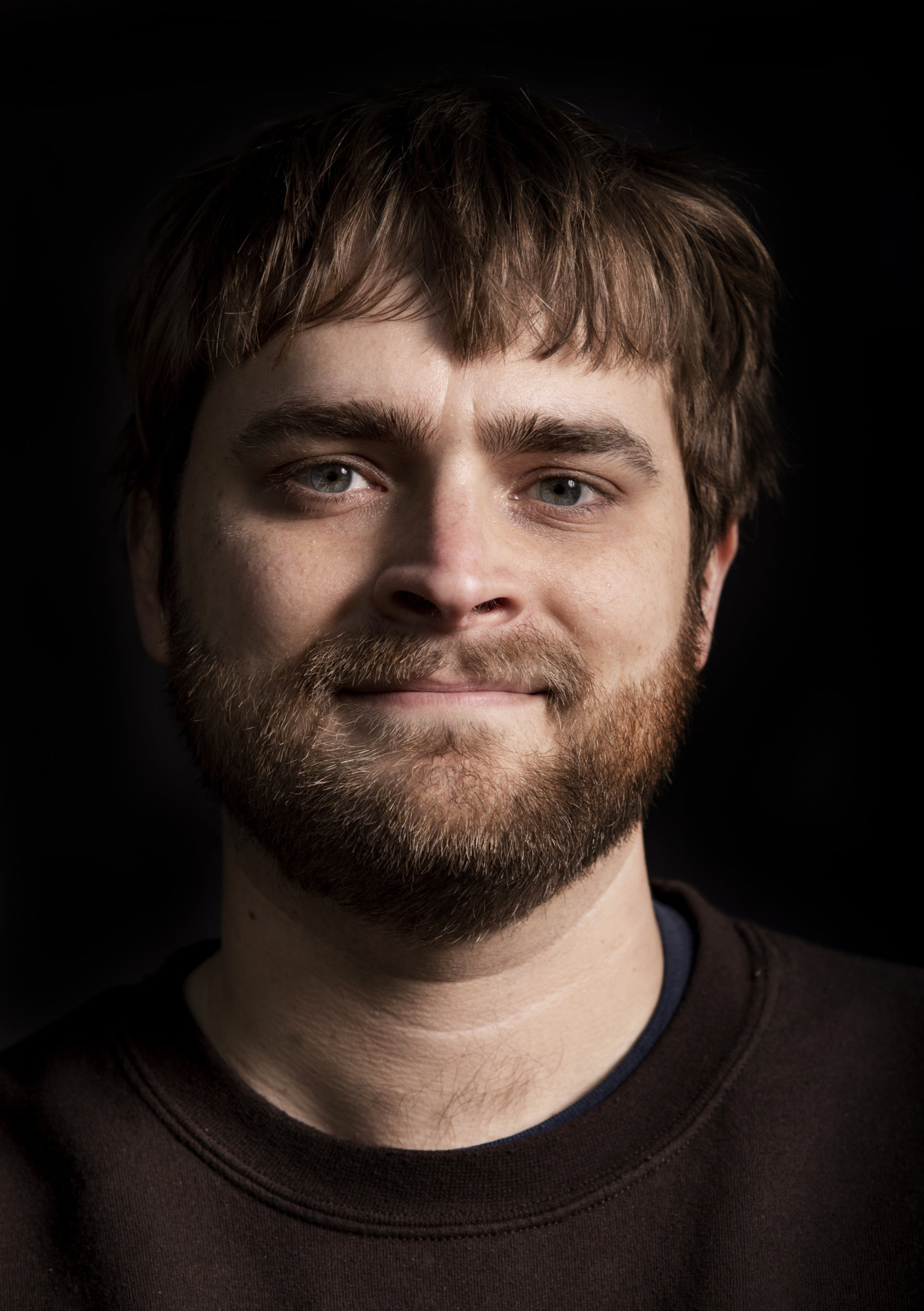 Headshot of Daniel M. Harris, Associate Professor of Engineering, wearing a dark sweater and smiling warmly at the camera.
