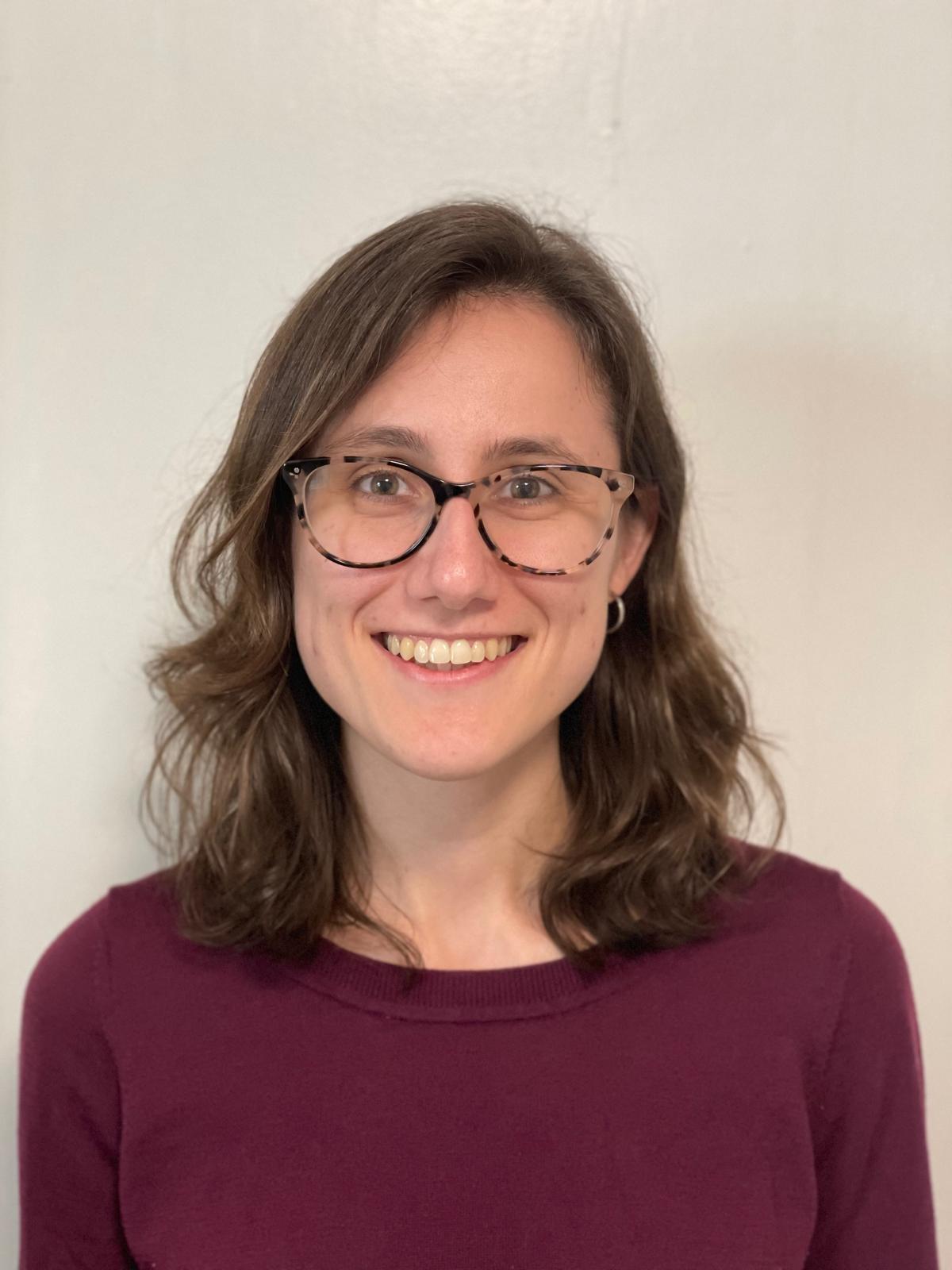 headshot of Anna Soifer in a burgundy shirt with a plain background