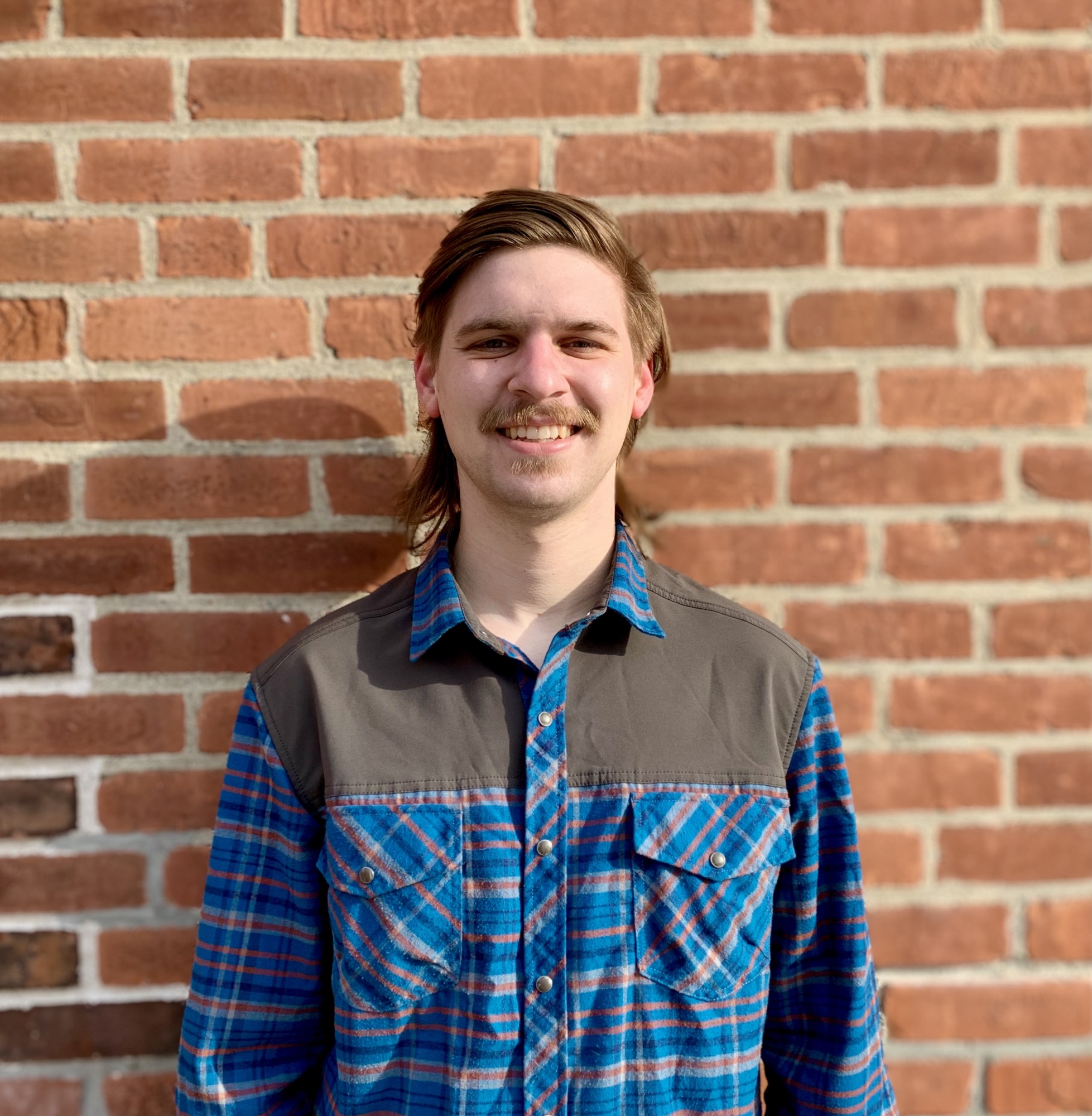 David Peede headshot against a brick wall