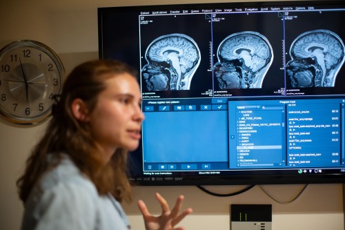 Graduate student at an MRI Facility showing brain scans