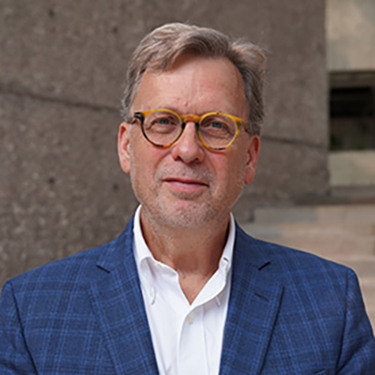 headshot of David Lindstrom in a dark jacket and white shirt